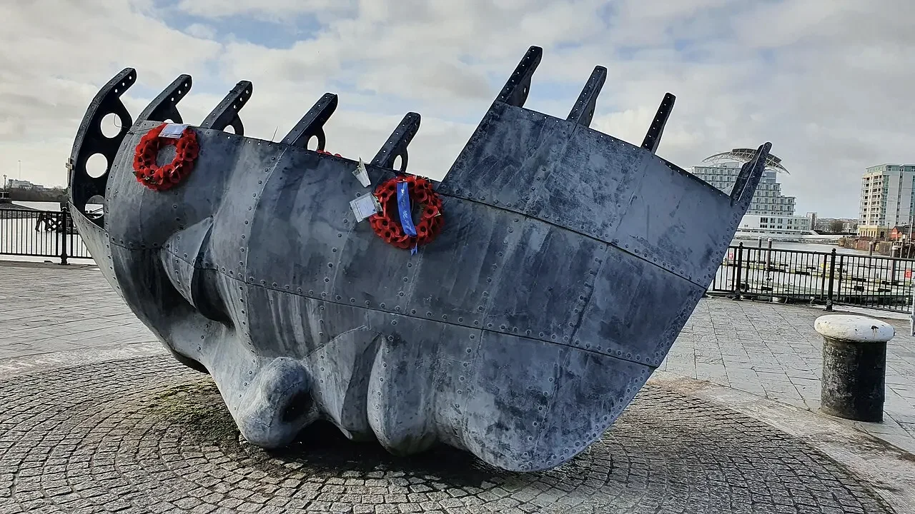 The Merchant Seafarers' War Memorial in Cardiff Bay, a sculpted head lying beside the waterfront